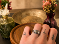 Ridged band ring worn on tattooed hand