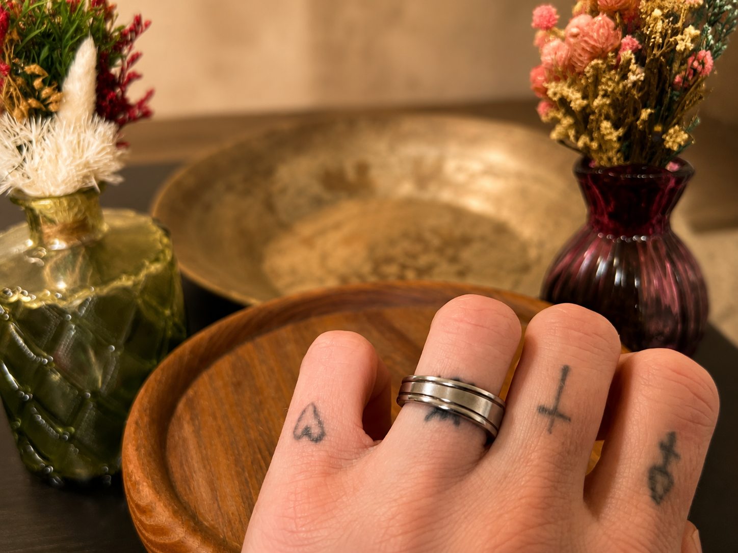 Ridged band ring worn on tattooed hand